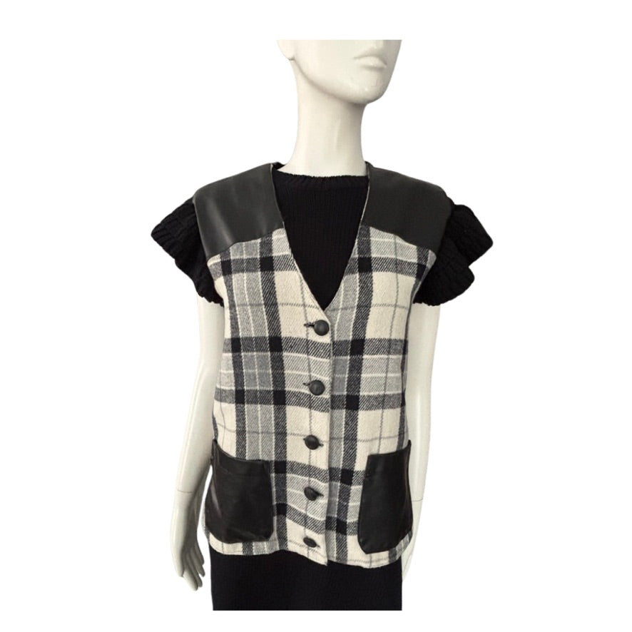 Mannequin wearing a black and white checkered vest with leather accents on a white background