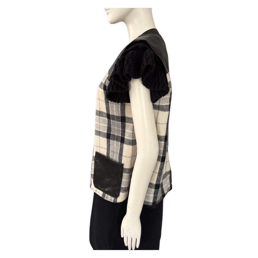 Mannequin wearing a black and beige checkered top with ruffled sleeves on a white background