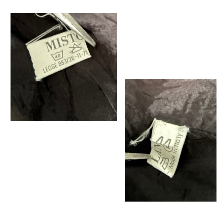 Close-up of clothing labels with 'Misto' and 'Lia' branding on a garment.