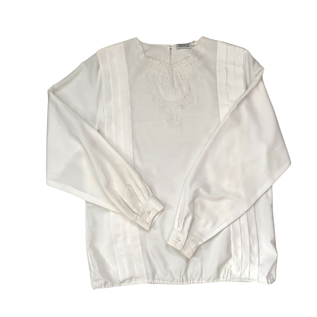 White blouse with lace details on a white background