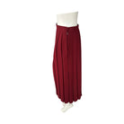 Red pleated skirt on a mannequin against a white background