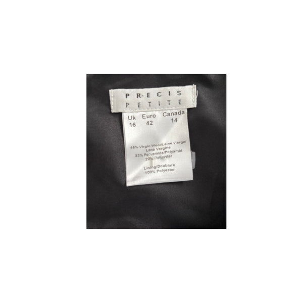 Clothing label with brand name 'PRECIS PETITE' on a black fabric background
