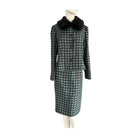 Plaid coat with black fur collar on a mannequin against a white background