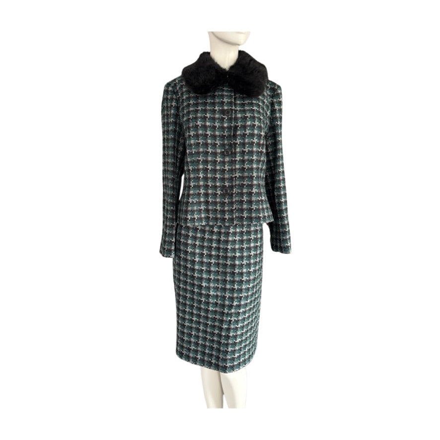 Plaid coat with black fur collar on a mannequin against a white background