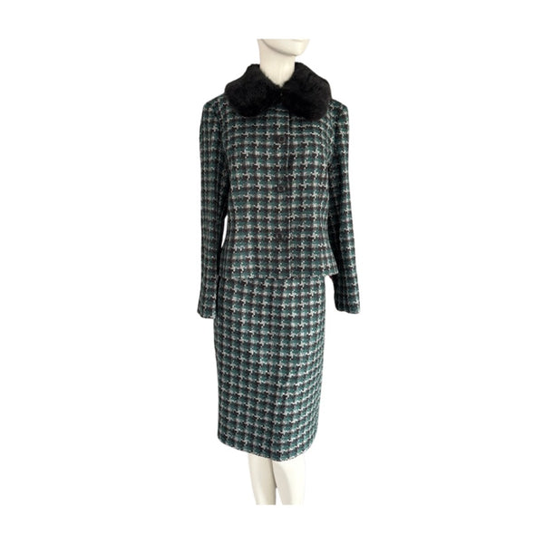 Plaid coat with black fur collar on a mannequin against a white background