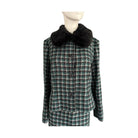 Plaid coat with black fur collar on a mannequin against a white background