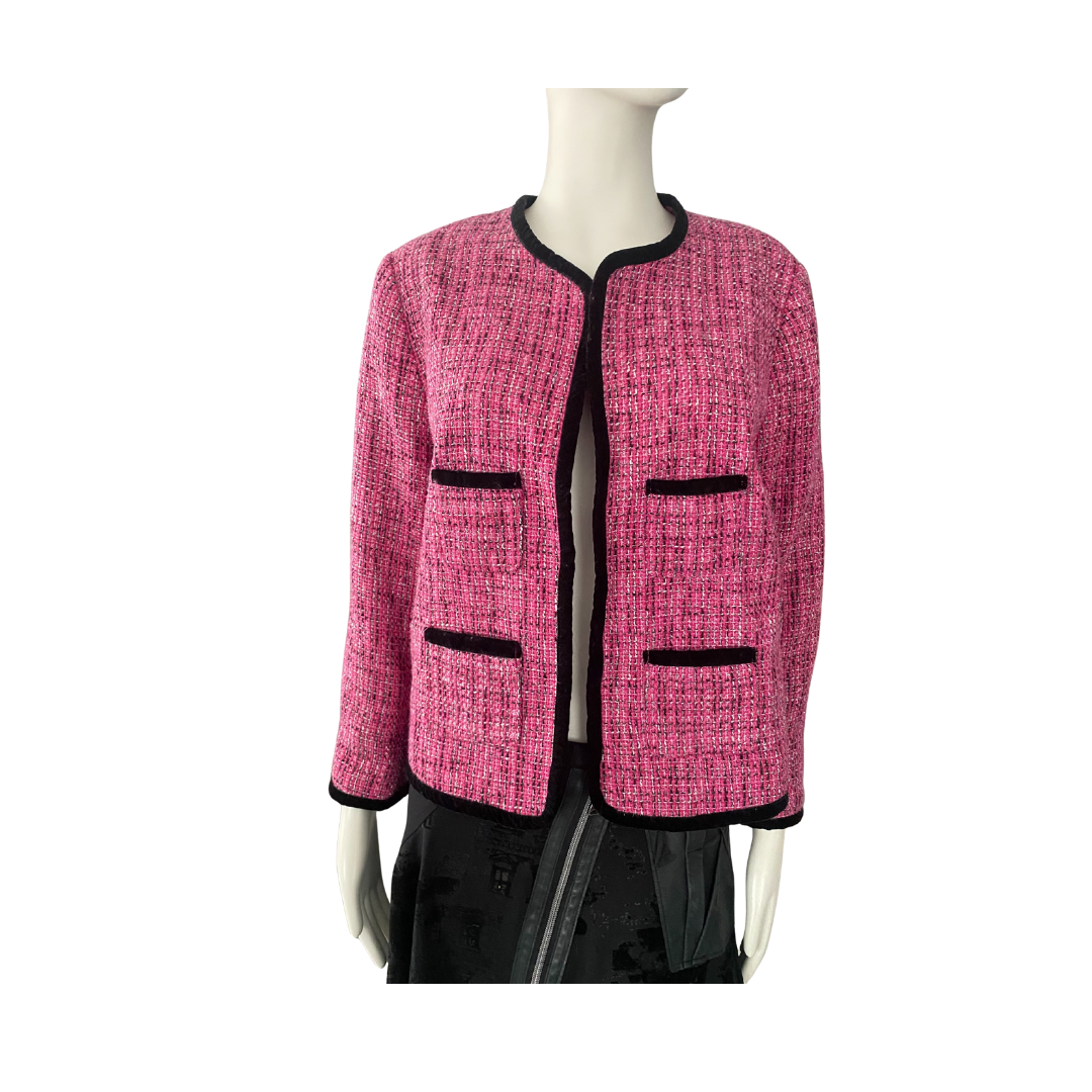 Pink tweed jacket with black accents on a mannequin against a white background