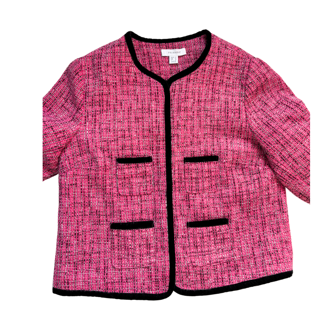 Pink textured jacket with black trim on a white background