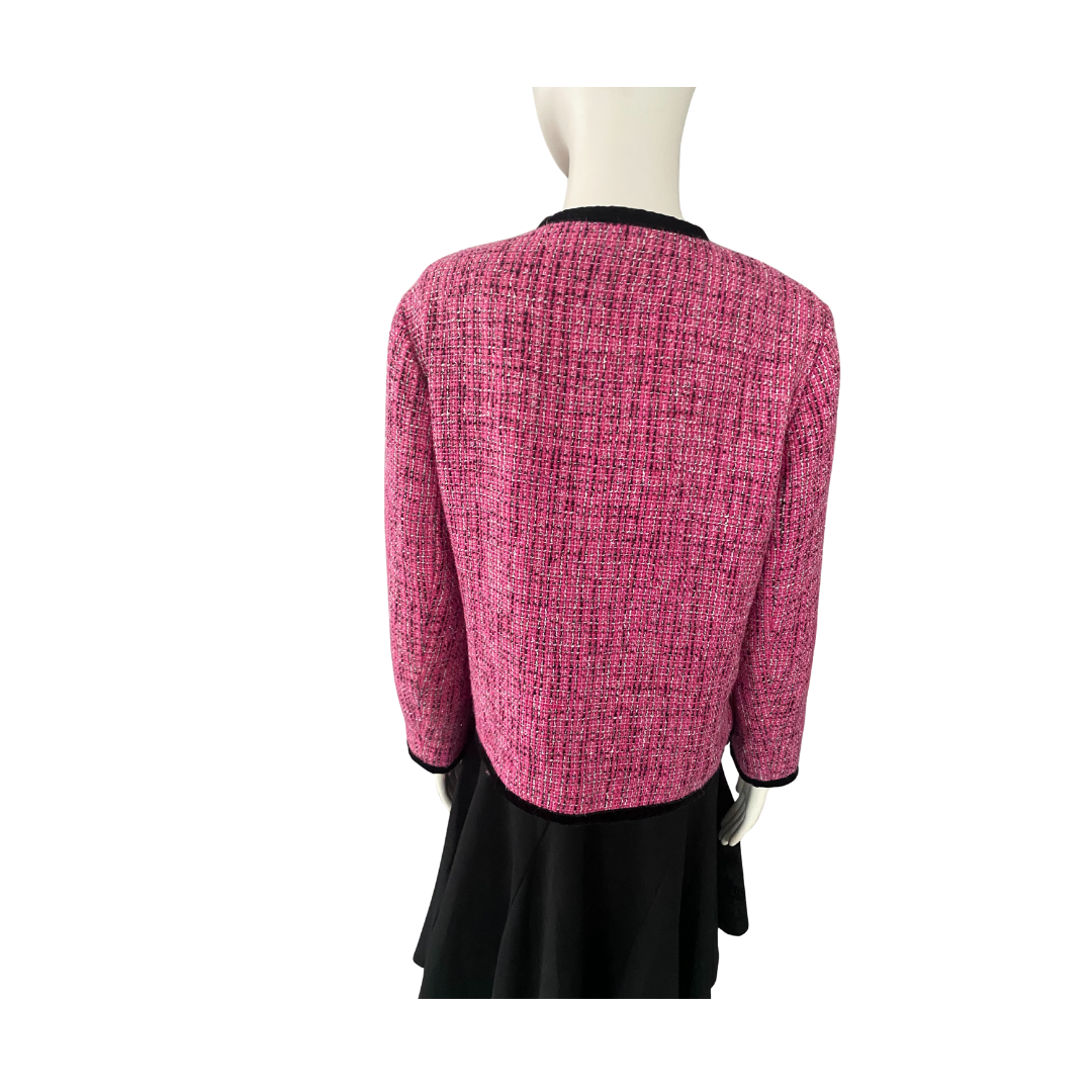 Mannequin wearing a pink textured jacket and black skirt on a white background