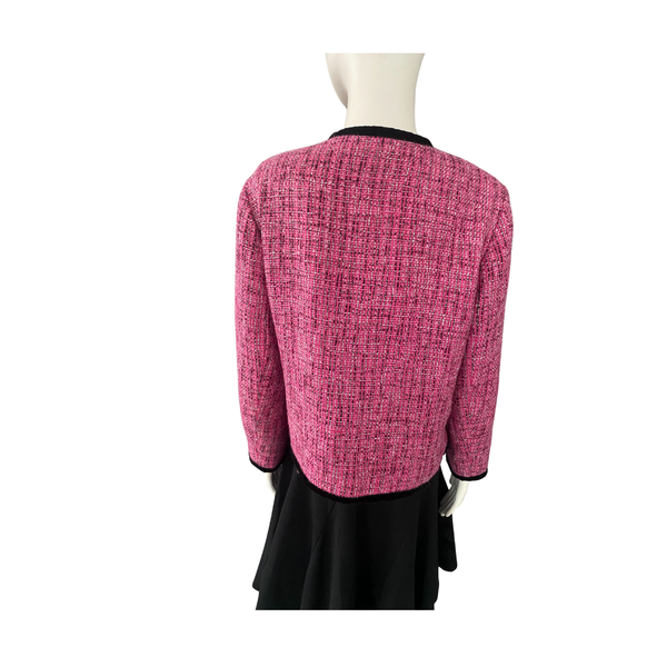 Mannequin wearing a pink textured jacket and black skirt on a white background