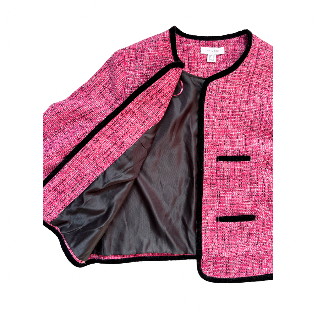 Pink textured jacket with black trim on a white background