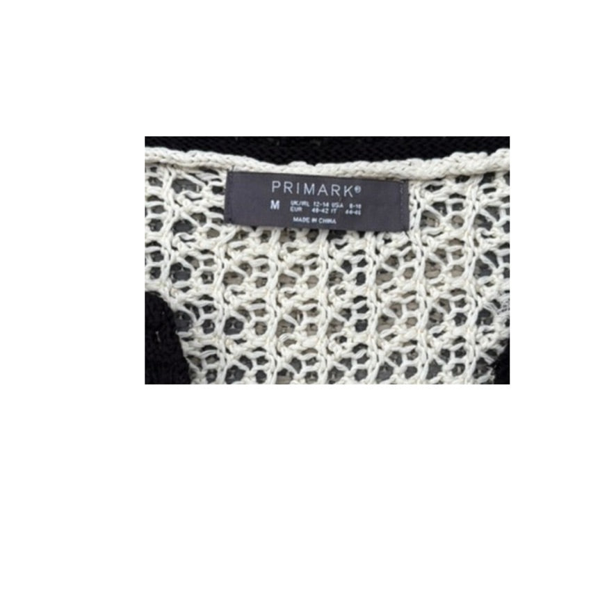 Close-up of a Primark label on a textured fabric background