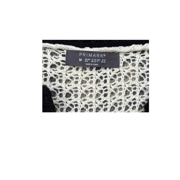 Close-up of a Primark label on a textured fabric background