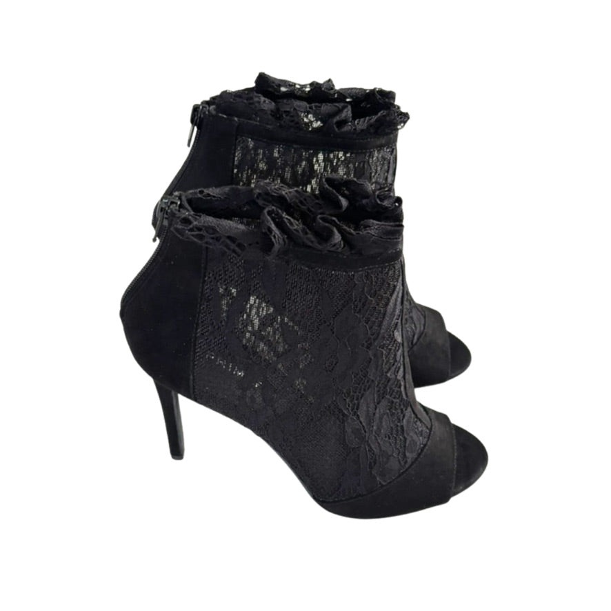 Black lace high-heeled shoes on a white background
