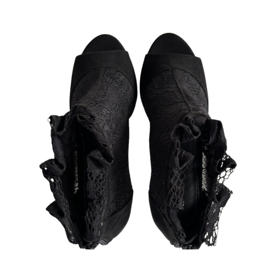 Pair of black lace-up shoes on a white background