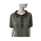 Mannequin wearing a patterned shirt with brown collar on a white background