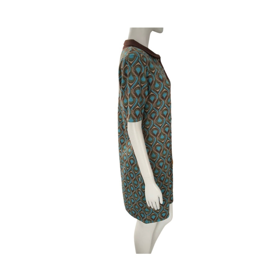 Mannequin wearing a patterned dress with a white background