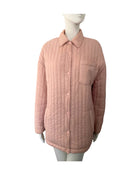 Quilted pink jacket on a mannequin against a white background