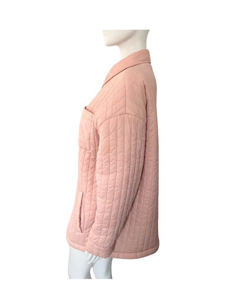 Pink quilted jacket on a mannequin against a white background