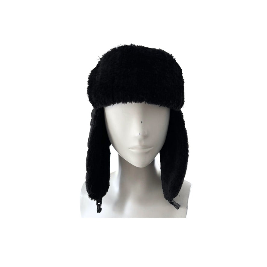 Black fur hat with ear flaps on a mannequin head against a white background