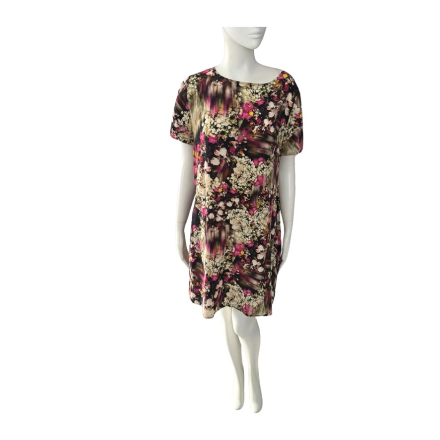 Floral dress on a mannequin against a white background