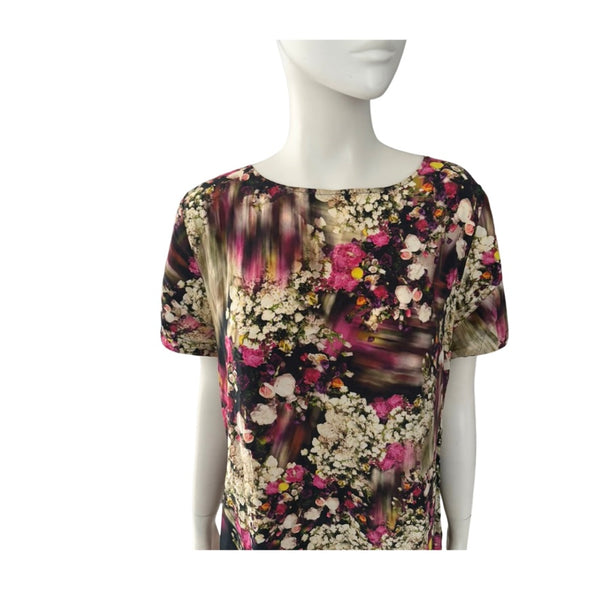 Mannequin wearing a floral patterned top on a white background