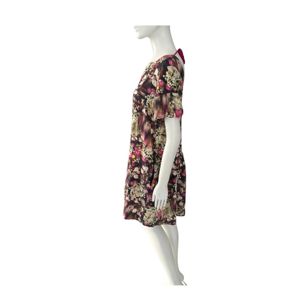 Floral dress on a mannequin against a white background