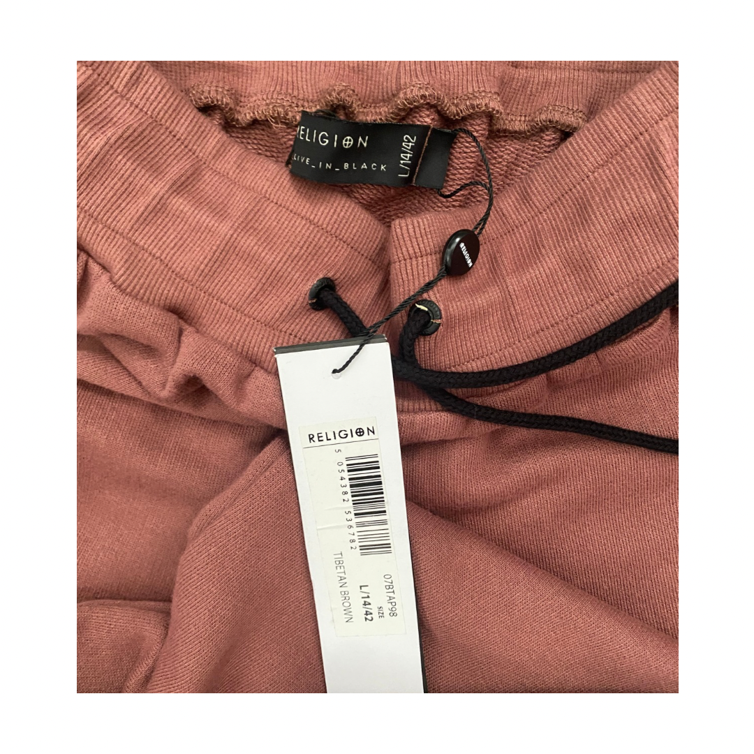 Pink garment with a brand tag on a white background