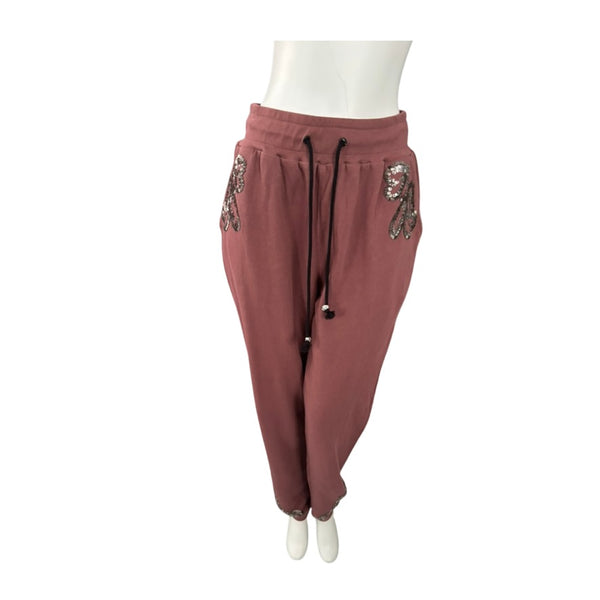 pink sweatpants with embellishments on a white background