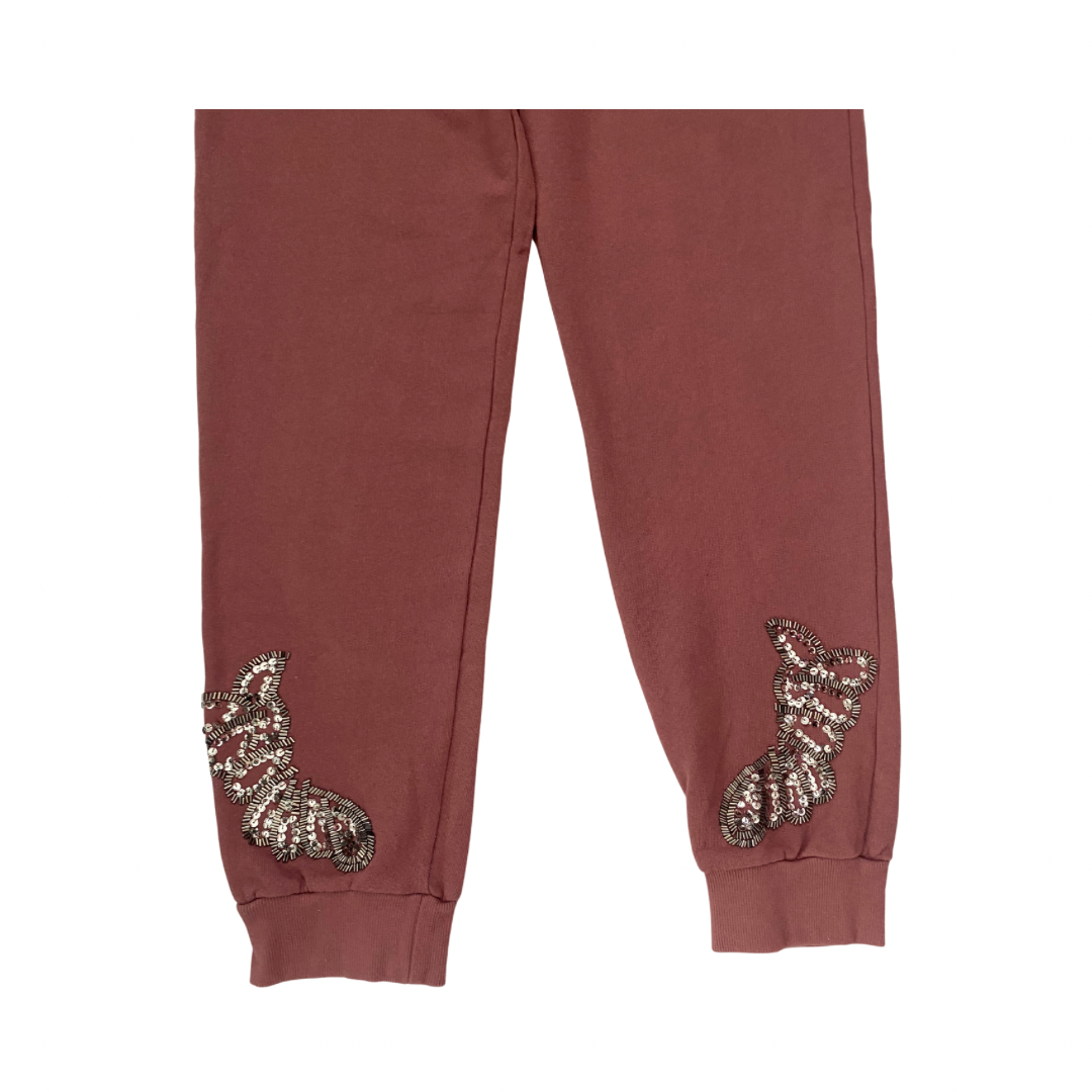 pink sweatpants with sequin embellishments on a white background
