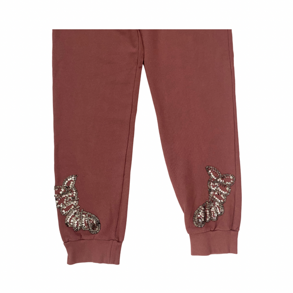 pink sweatpants with sequin embellishments on a white background