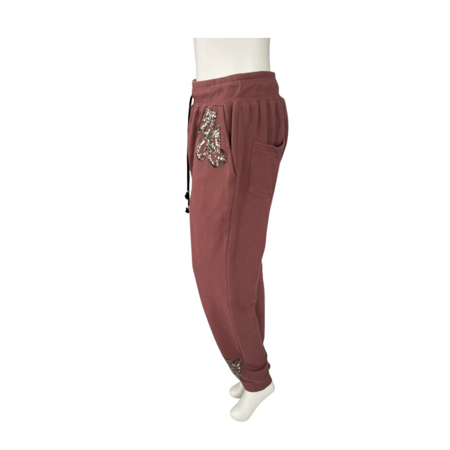 pink jogger pants with sequin embellishments on a white background