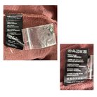 Close-up of clothing labels and tags on a fabric background