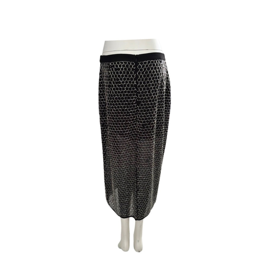 Black fishnet skirt on a mannequin against a white background