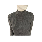 Grey textured sweater on a mannequin against a white background