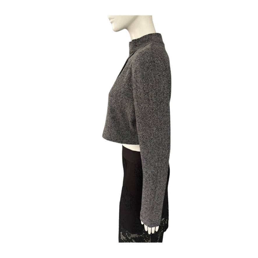 Mannequin wearing a gray textured sweater with a white background