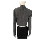 Mannequin wearing a gray textured long-sleeve top on a white background