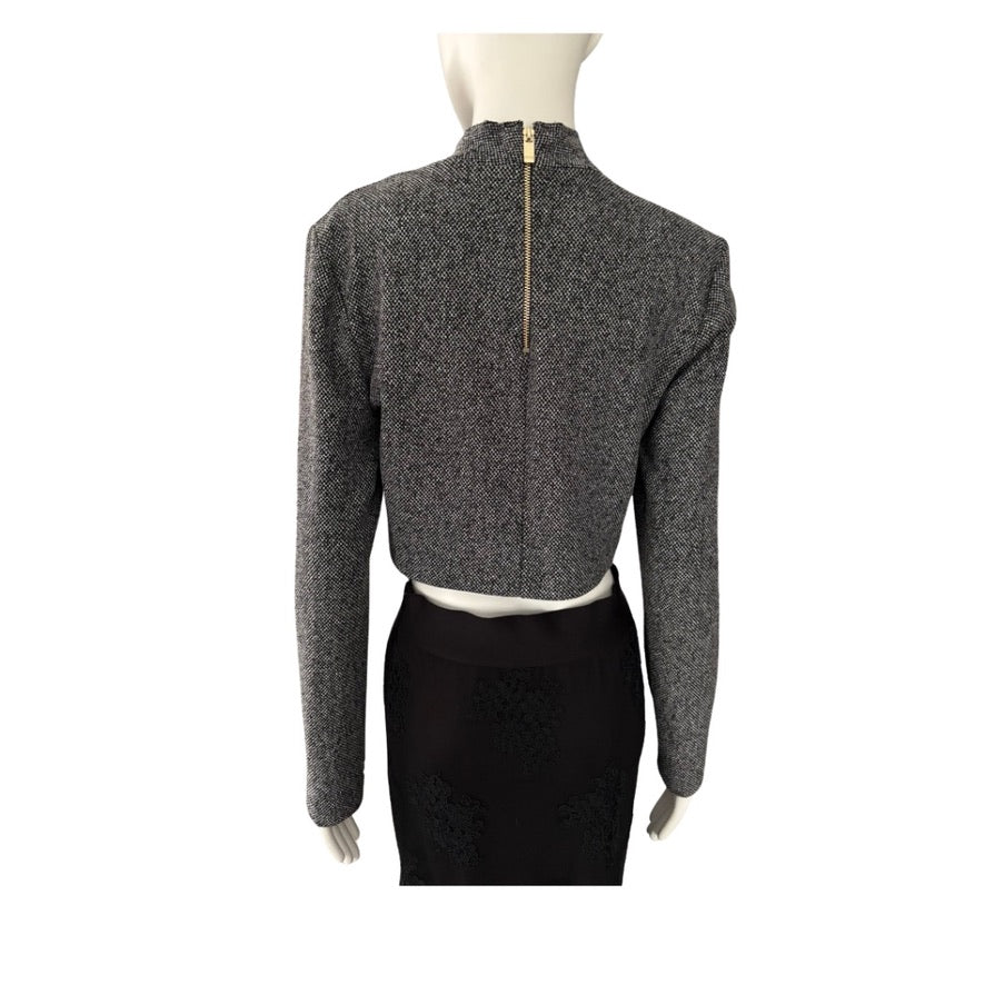 Mannequin wearing a gray textured long-sleeve top on a white background