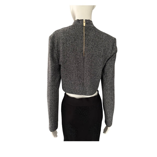 Mannequin wearing a gray textured long-sleeve top on a white background