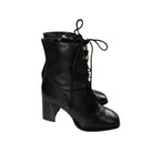 Black lace-up boots on a white background