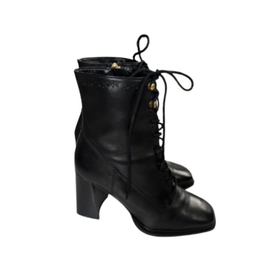 Black lace-up boots on a white background