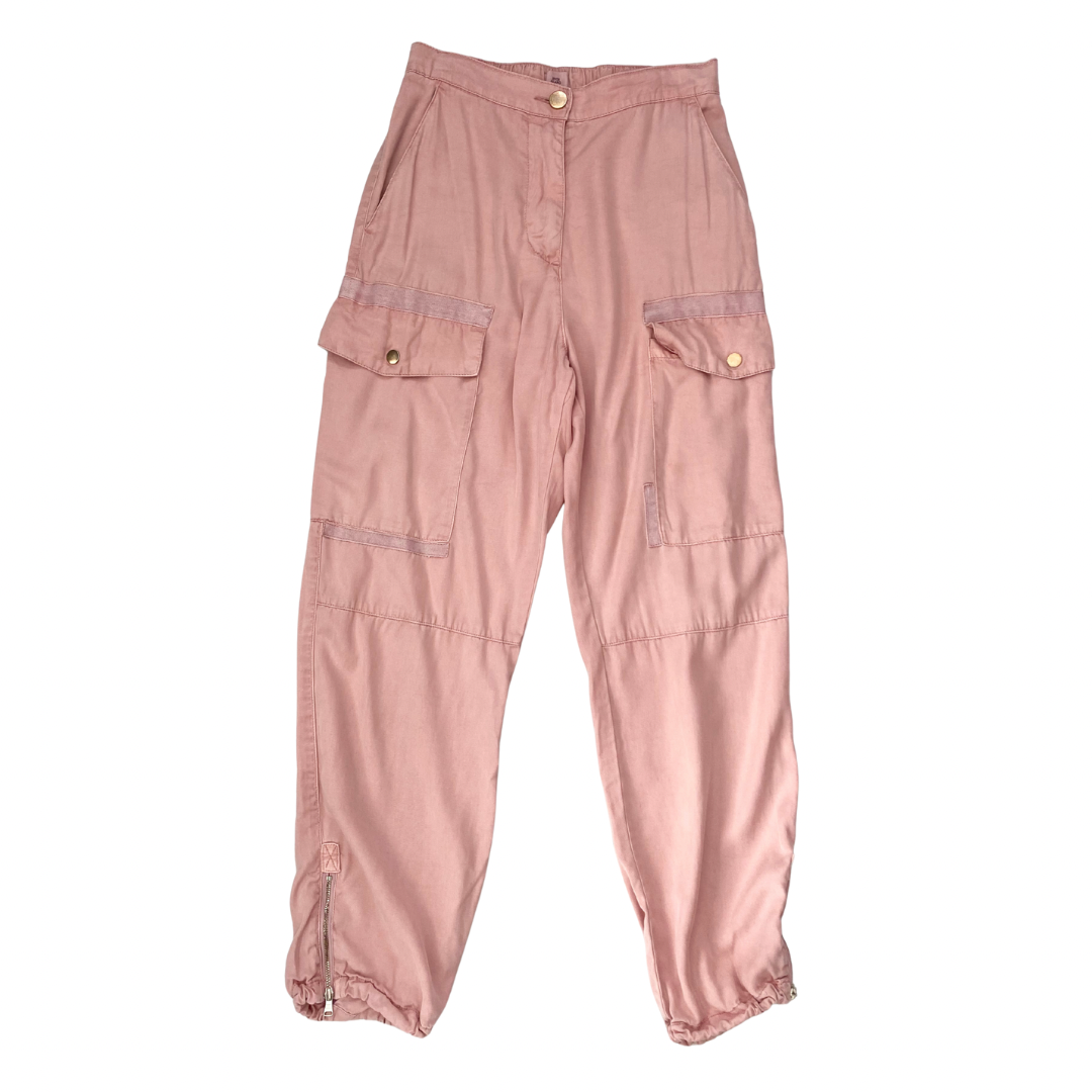 Pink cargo pants on a white background