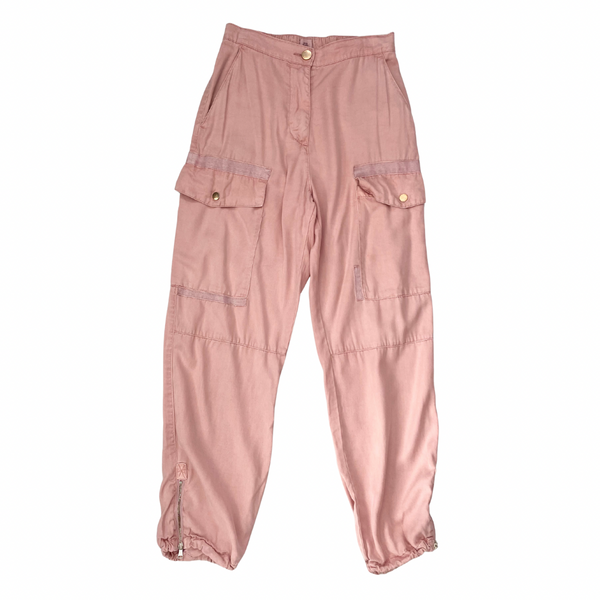 Pink cargo pants on a white background