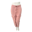Pink cargo pants on a mannequin against a white background