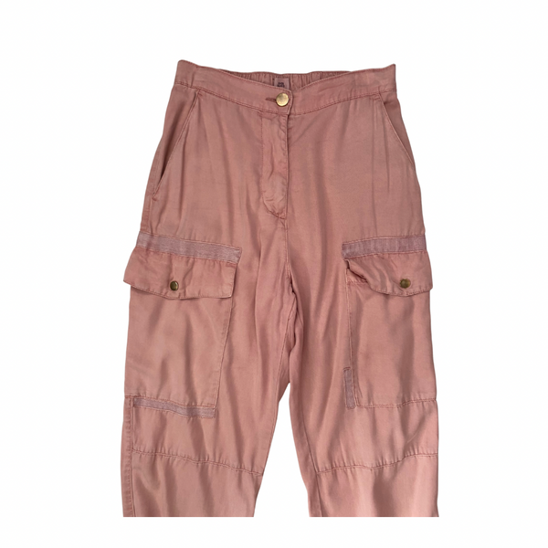 Pink cargo pants on a white background