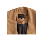 Tan coat with a visible River Island label on a white background