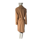 Tan trench coat on a mannequin against a white background