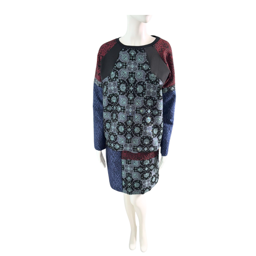 Mannequin wearing a patterned dress with blue, red, and black colors on a white background