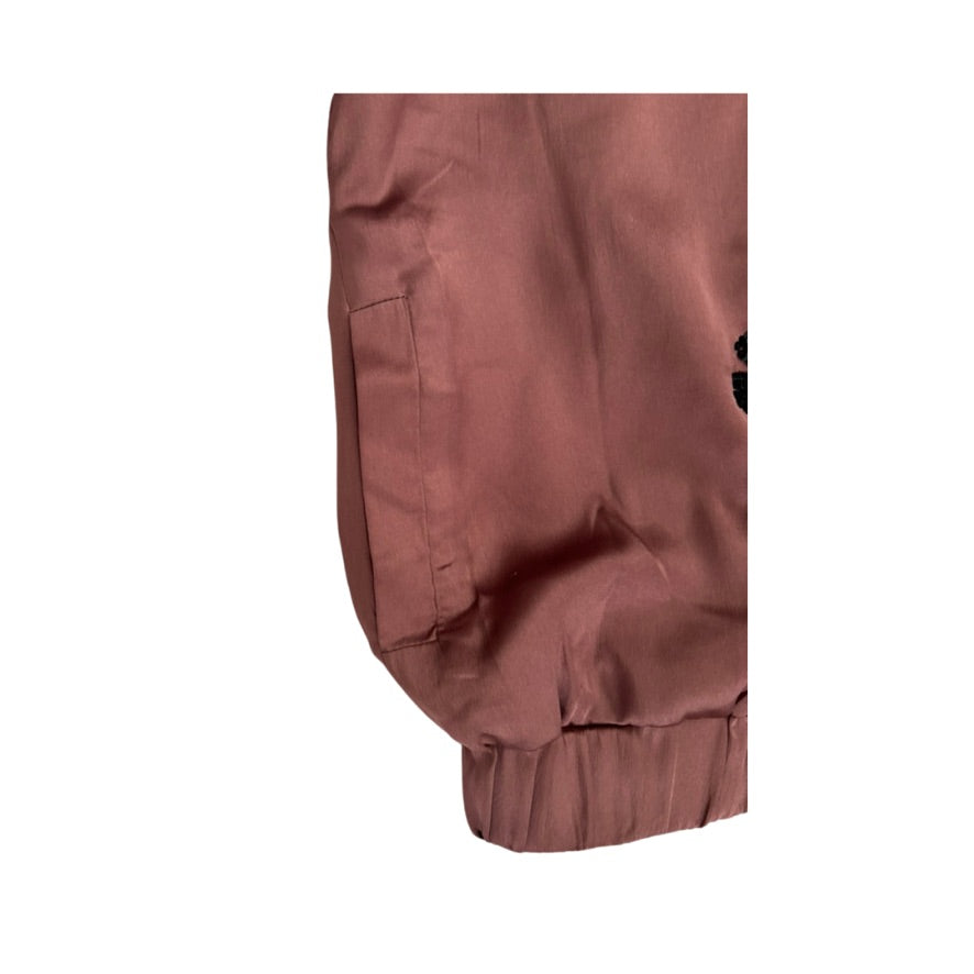 Close-up of a brown jacket with a white background