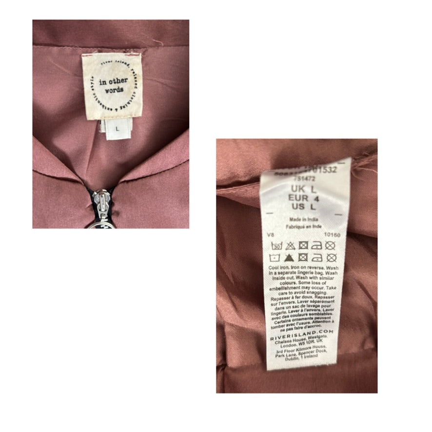 Close-up of a clothing tag on a garment with visible text and symbols.